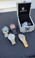 All five wristwatches and Smith & Wesson case displayed