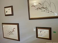 Wall view showing two small framed prints among others