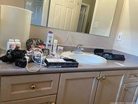 Bathroom countertop showing majority of items