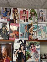 Shelf view showing 10 boxed figures across two rows