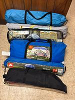 Stack of six tent carry bags showing overall lot