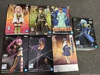 Front view showing seven boxed figures and character artwork