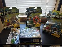 overview of four B-Daman Crossfire blister-packed toys on tabletop