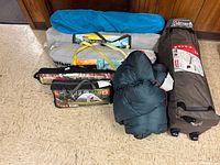 All items grouped together showing tents, cot bag, sleeping bags