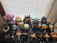 Full group of 21 loose Funko Pop figures on shelf