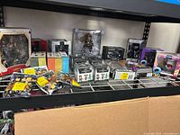 Wide view of shelf with various boxed and bagged collectible toys