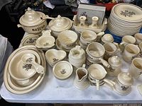 Wide view of Pfaltzgraff Village stoneware pieces on table