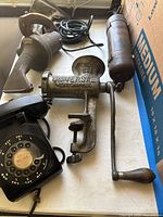 Overview showing telephone, meat grinder, drill, cylindrical tool