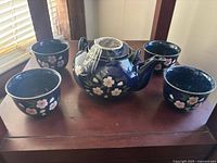 Full view showing teapot and four matching cups