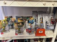 Front view showing multiple Legend of Zelda Amiibo, Cloud Amiibo, Disney Infinity Mickey, orange accessory, and several Kingdom Hearts figures