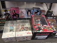 Overall lot of ten boxed anime figures displayed on shelf