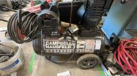 Overall view of Campbell Hausfeld Professional air compressor with hose and power cord