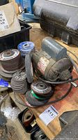 Motor and stacked abrasive discs on workbench