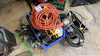 crate containing coiled extension cords, power bars, cable bundles