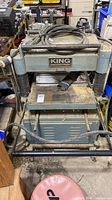 Front view of King Industrial planer on wheeled base