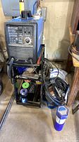 Welder on stand with accessories visible