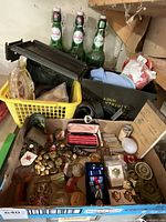 Overall lot showing beer bottles, ammunition boxes, yellow basket and box of militaria