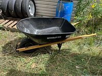 Full view of Seymour S300 DuraLite wheelbarrow showing poly tub, wood handles, pneumatic wheel