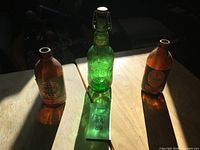 Three beer bottles on table