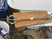 Both mixer paddles on wood board