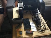 Overall lot showing hard drive, phone, speaker, flash drives, microSD card, cables