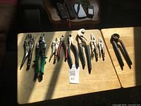 All eight hand tools laid out on tabletop, full view