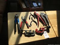 Top view of seven cutting and crimping tools on tabletop