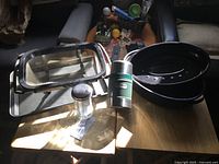 Group shot showing all four items: enamel roaster with lid, Stanley thermos, sink strainer, rectangular roasting tray with glass lid