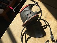 Full view of Jobmate palm sander with cord on tabletop