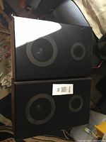 Front view of both speakers with grille cloth and driver outlines