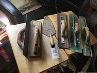 Group shot of five masonry tools on table