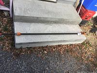 Full view of the 6-ft black pipe clamp on concrete step