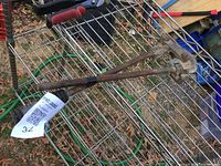 Full view of manual pipe bender lying on wire rack