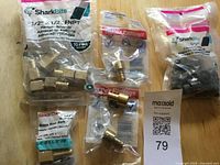 All packaged fittings: SharkBite female adapter 10-pack, PEX male adapters, clamp rings bag, Sioux Chief hose barb