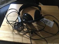 Headset resting on table showing earcups, headband, cable and USB connector