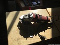 Full view of Skil angle grinder showing body, blade, and cord