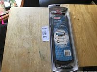 Front view of sealed Coleman 2.5W solar charger package on table