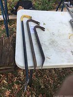 Three crowbars on table showing size differences and condition