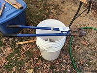 Full view of bolt cutter resting on bucket