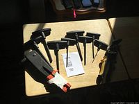 Tools displayed on table: seven T-handle Torx screwdrivers, black rivet gun with orange handles, yellow/black aviation snips