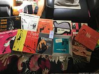 Group shot of ten jazz LPs laid on rug showing front covers