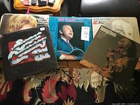 Five LP covers visible: Super Country '81, Roy Clark, Tammy Wynette titles, Merle Haggard, others stacked beneath