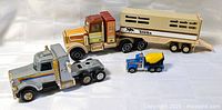 All four toy vehicles grouped