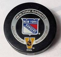 Front of puck showing New York Rangers crest, date January 20 2004, opponent Boston Bruins