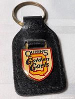 Front view showing Queen's Golden Gaels enamel shield and leather fob