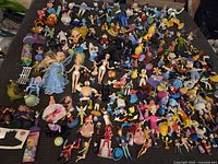 Entire spread of mixed Disney figurines and dolls laid out on surface