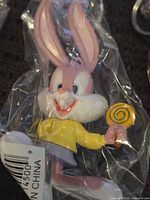 Close-up of Baby Bugs Bunny figure in sealed bag