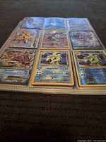 Overview of first binder page showing 9 Pokémon cards with notable holos