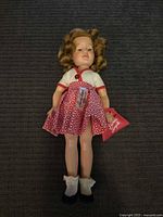 Full view of Shirley Temple doll with outfit and accessories