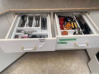 Drawer with cutlery tray and utensil tray showing overall contents